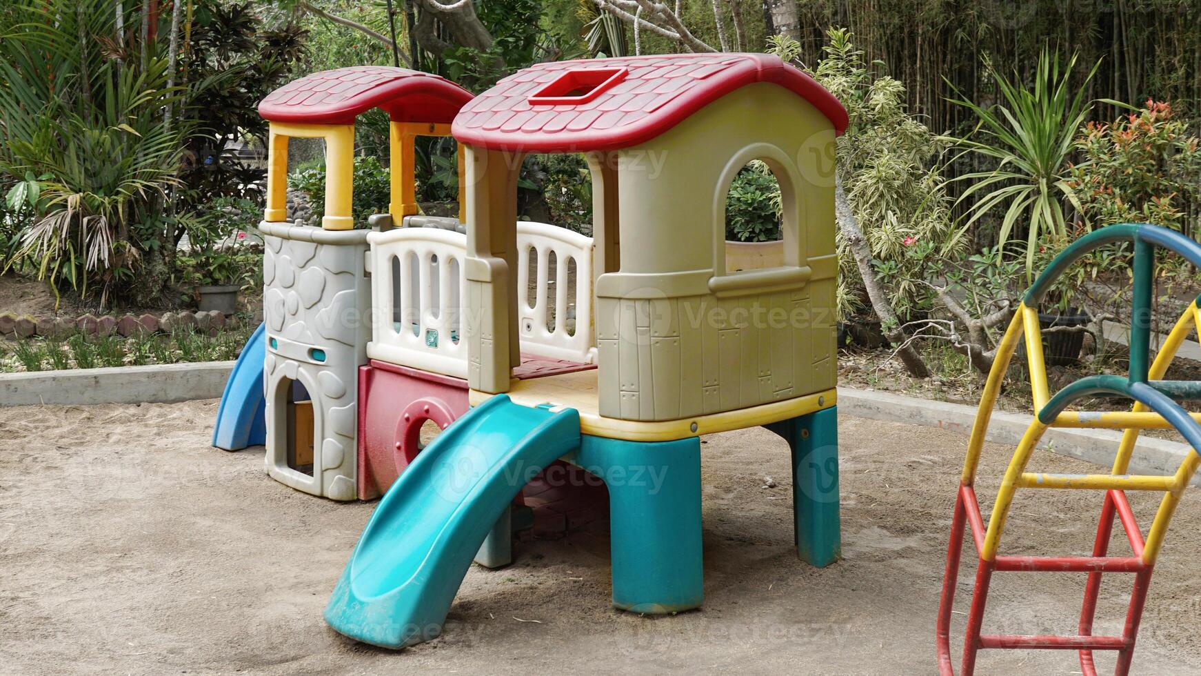 Colorful children's playground in the garden courtyard protected with sandbox photo