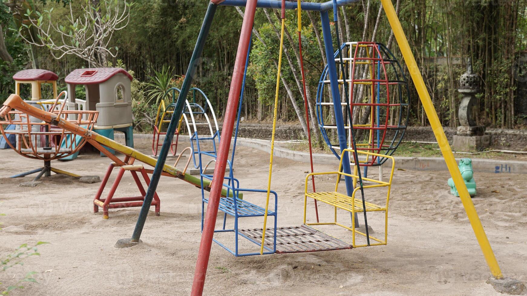 Colorful children's playground in the garden courtyard protected with sandbox photo