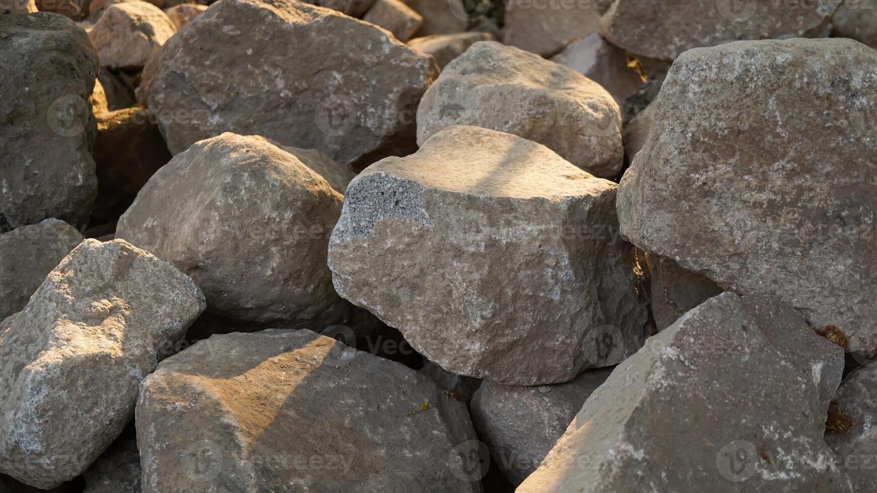 Pile of limestone gravel at a construction site illuminated by sunlight. photo