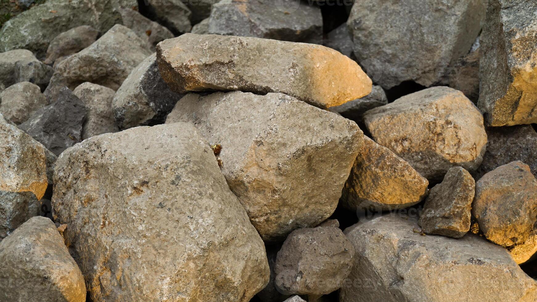 Pile of limestone gravel at a construction site illuminated by sunlight. photo