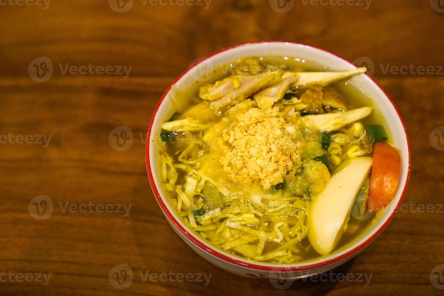 Soto ayam is a typical Indonesian food in the form of a type of chicken soup with a yellowish sauce photo