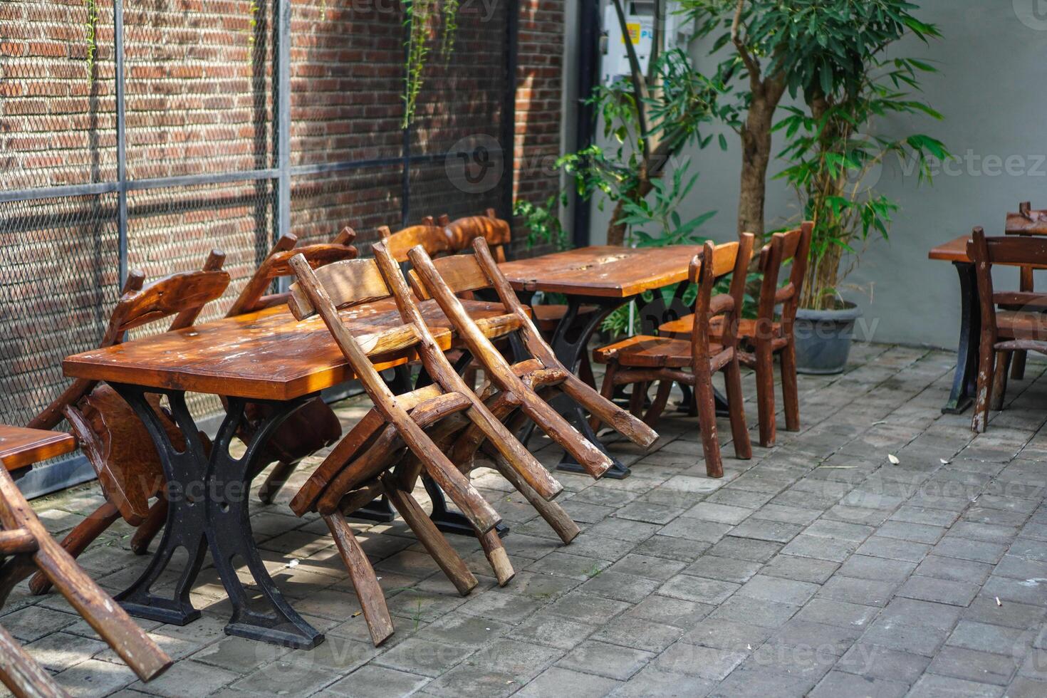 simple minimalist wooden tables and chairs for sitting and drinking coffee in a coffee shop with a natural atmosphere photo