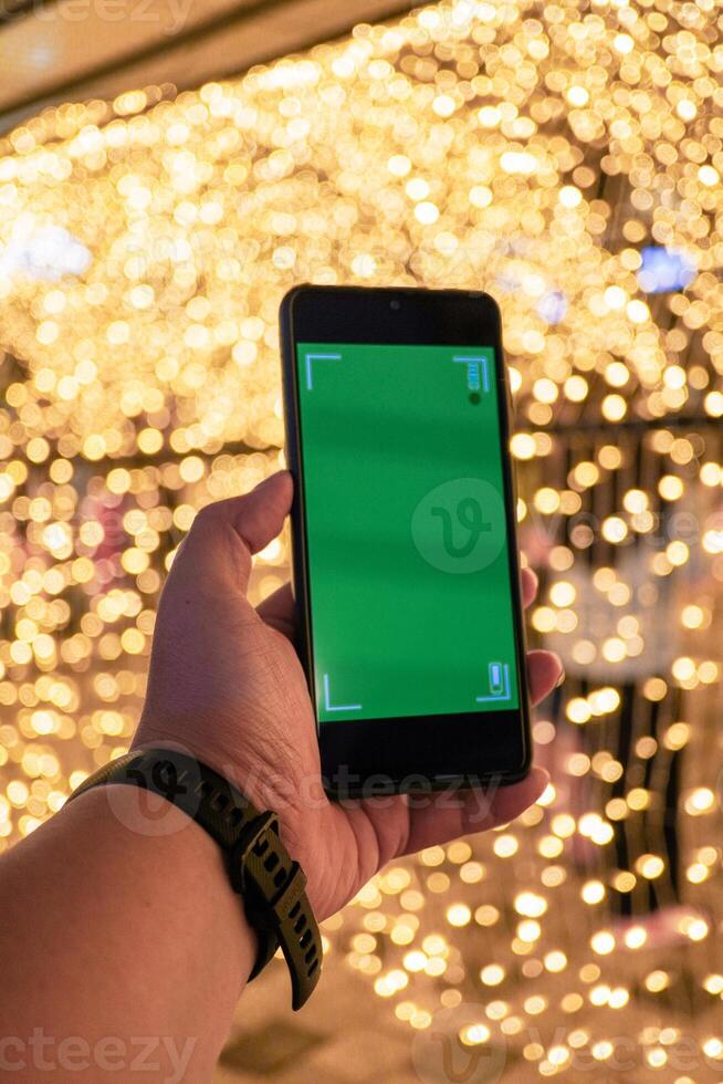 a man's hand holding a smartphone is recording a to immortalize the moment photo