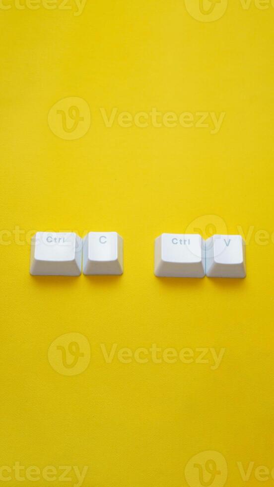 Ctrl C, Ctrl V keyboard buttons, copy and paste key shortcut isolated on a yellow background. photo