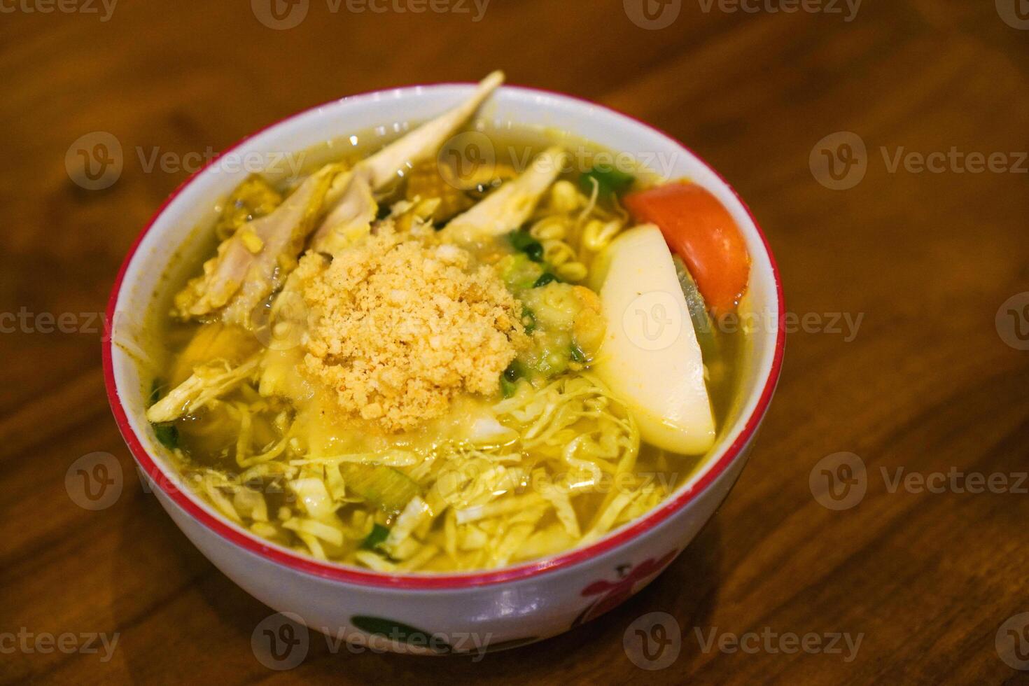 Soto ayam is a typical Indonesian food in the form of a type of chicken soup with a yellowish sauce photo