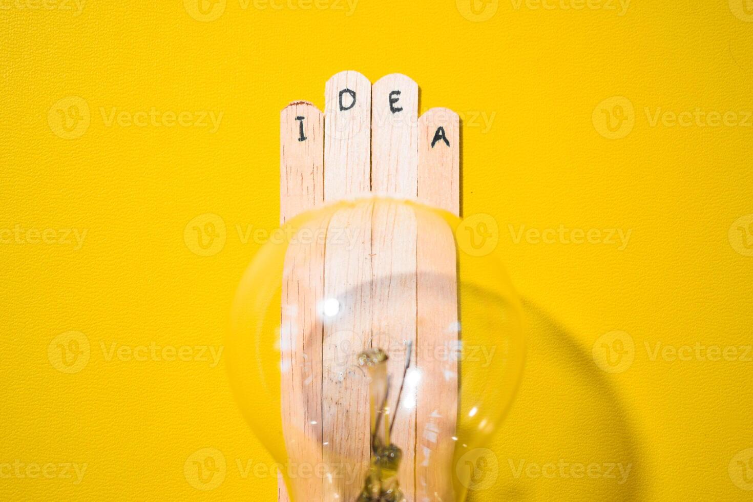 stick of ice cream with the words Idea and lightbulb. Motivational quotes, optimism, positive words. Isolated on background photo