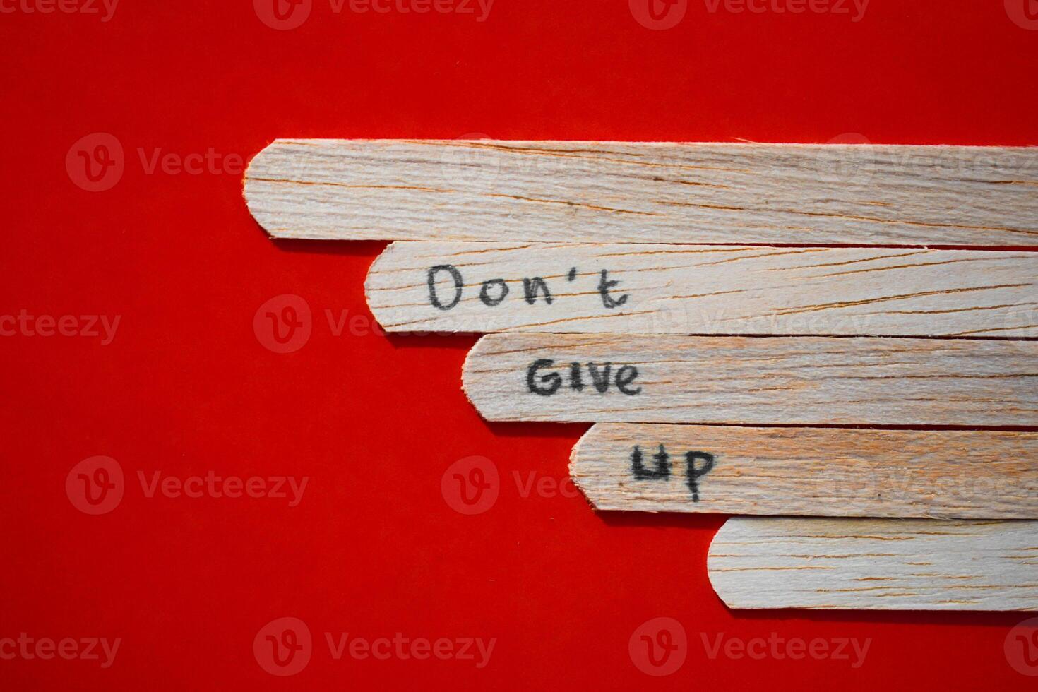 stick of ice cream with the words Never Give Up. Motivational quotes, optimism, positive words. Isolated on background photo