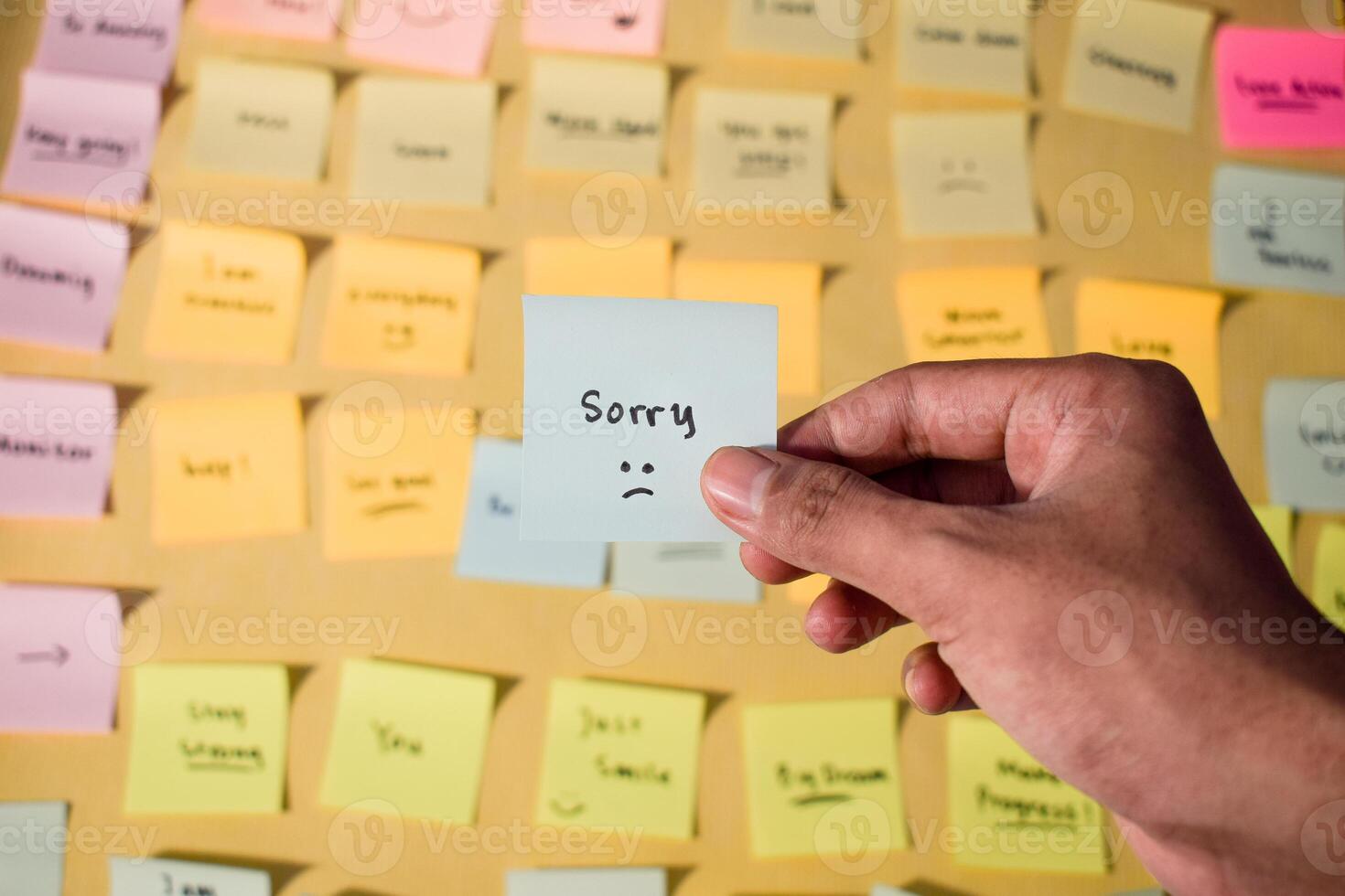 Hand hold sticky notes with words sorry, Motivational for personal development, inspirational handwriting. Sticky notes background photo