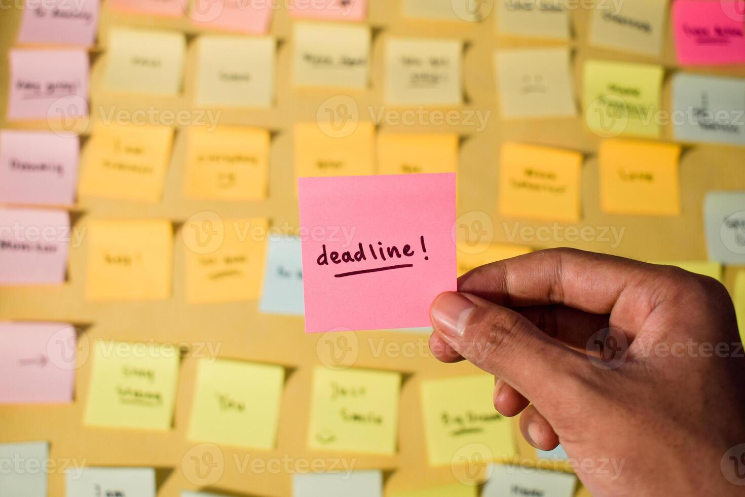 Hand hold sticky notes with words Deadline. Motivational words for personal development, inspirational handwriting. Sticky notes background photo
