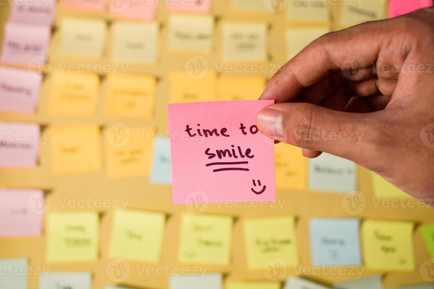 Hand hold sticky notes with words Time to Smile. Motivational words for personal development, inspirational handwriting. Sticky notes background photo