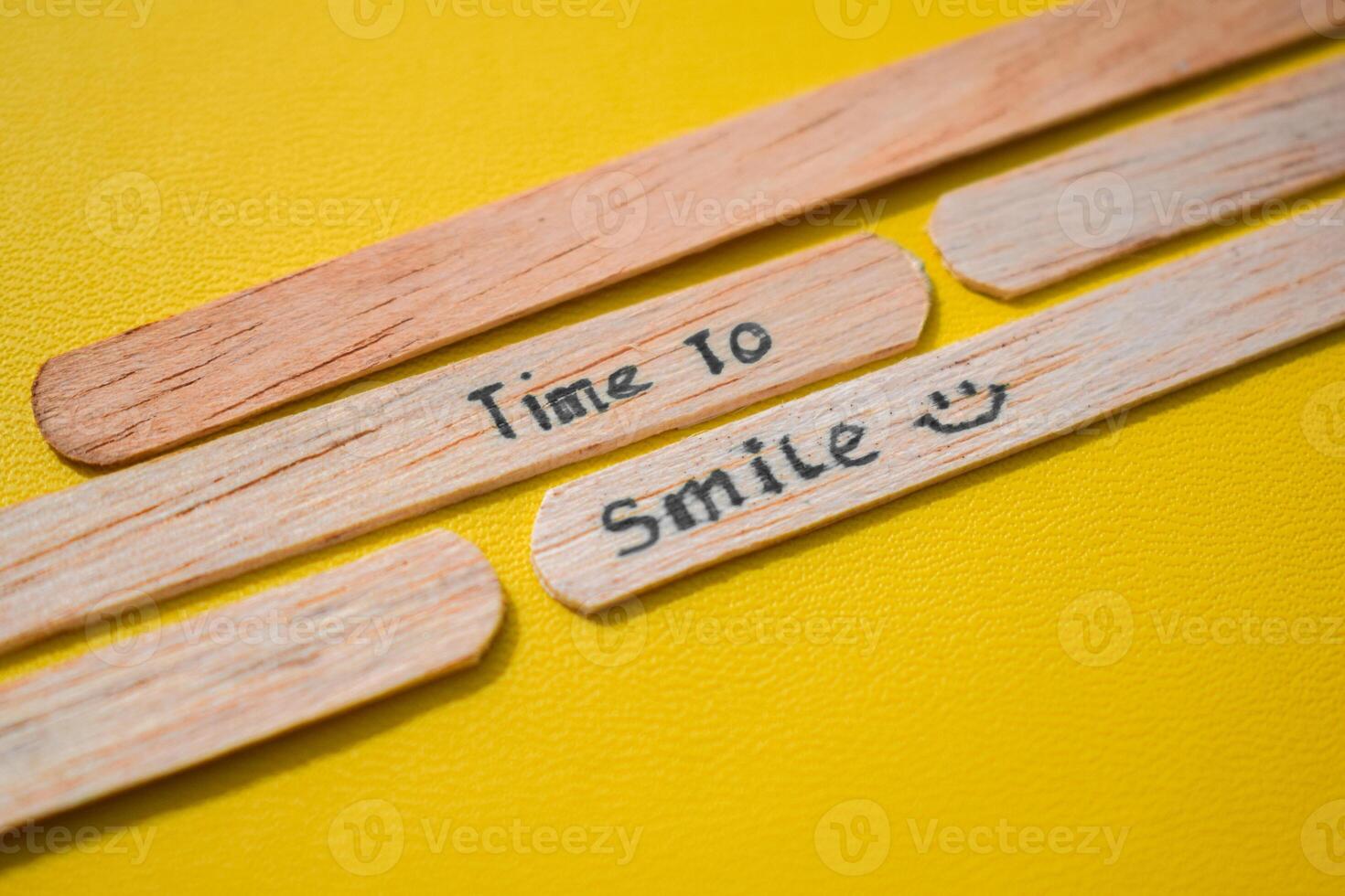 stick of ice cream with the words time to smile. Motivational quotes, optimism, positive words. Isolated on background photo