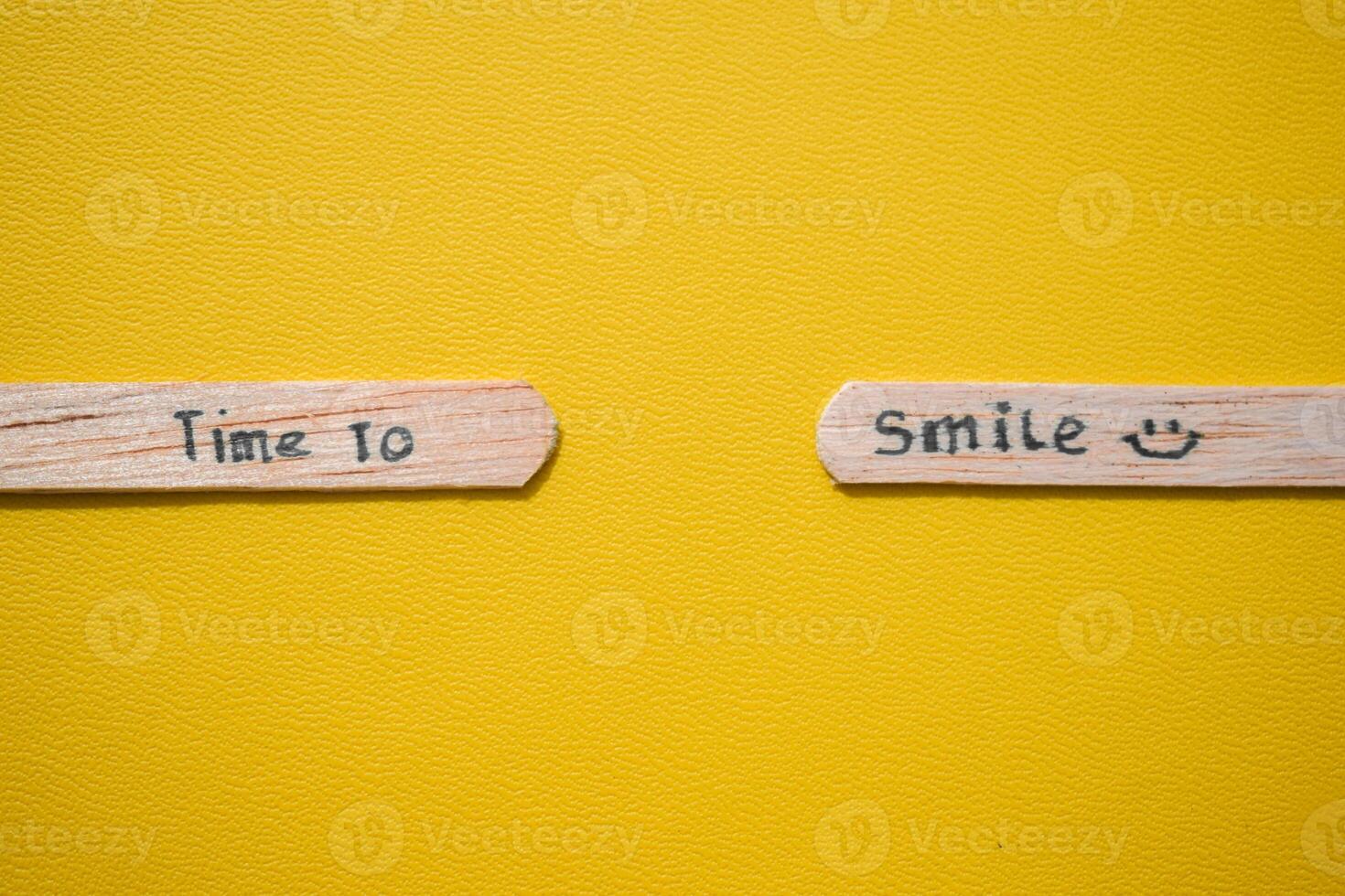 stick of ice cream with the words time to smile. Motivational quotes, optimism, positive words. Isolated on background photo