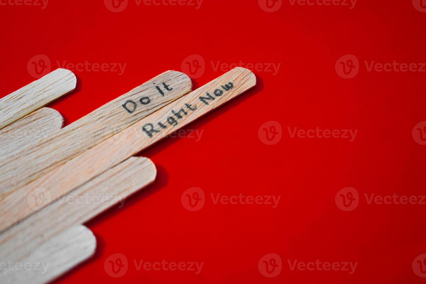 stick of ice cream with the words Do it right now. Motivational quotes, optimism, positive words. Isolated on background photo