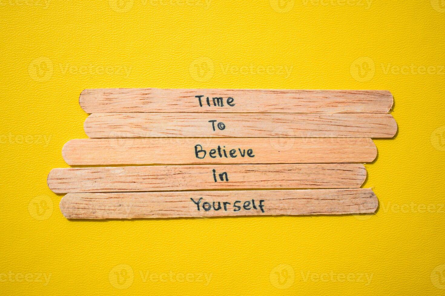 stick of ice cream with the words time to believe in yourself. Motivational quotes, optimism, positive words. Isolated on background photo