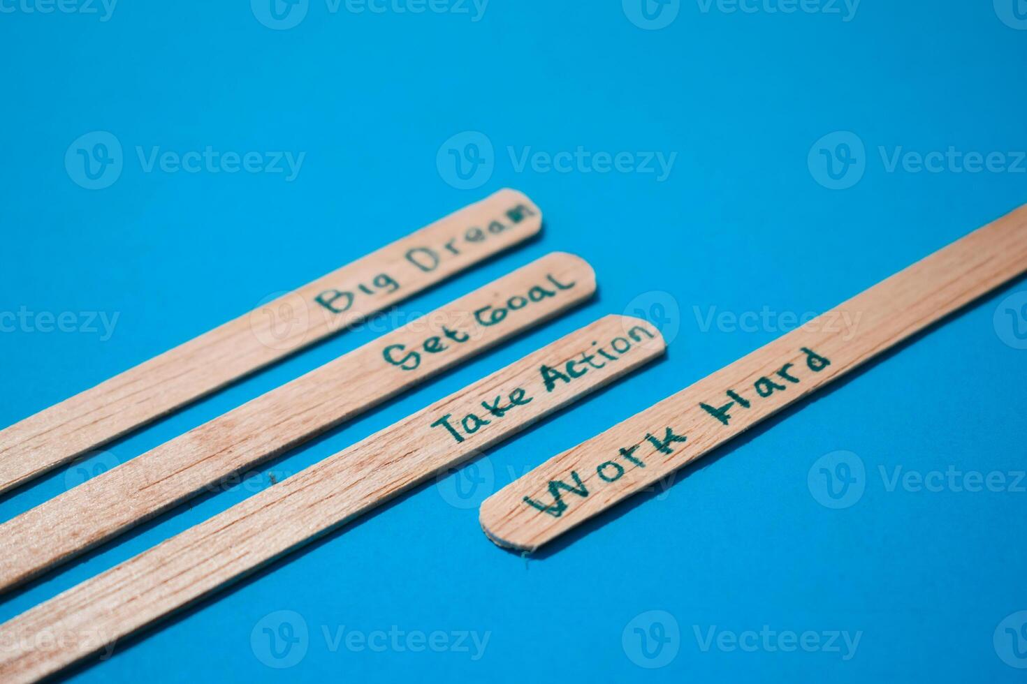 stick of ice cream with the words Big dream, Get goal, Take action, Work hard. Motivational quotes, optimism, positive words. Isolated on background photo