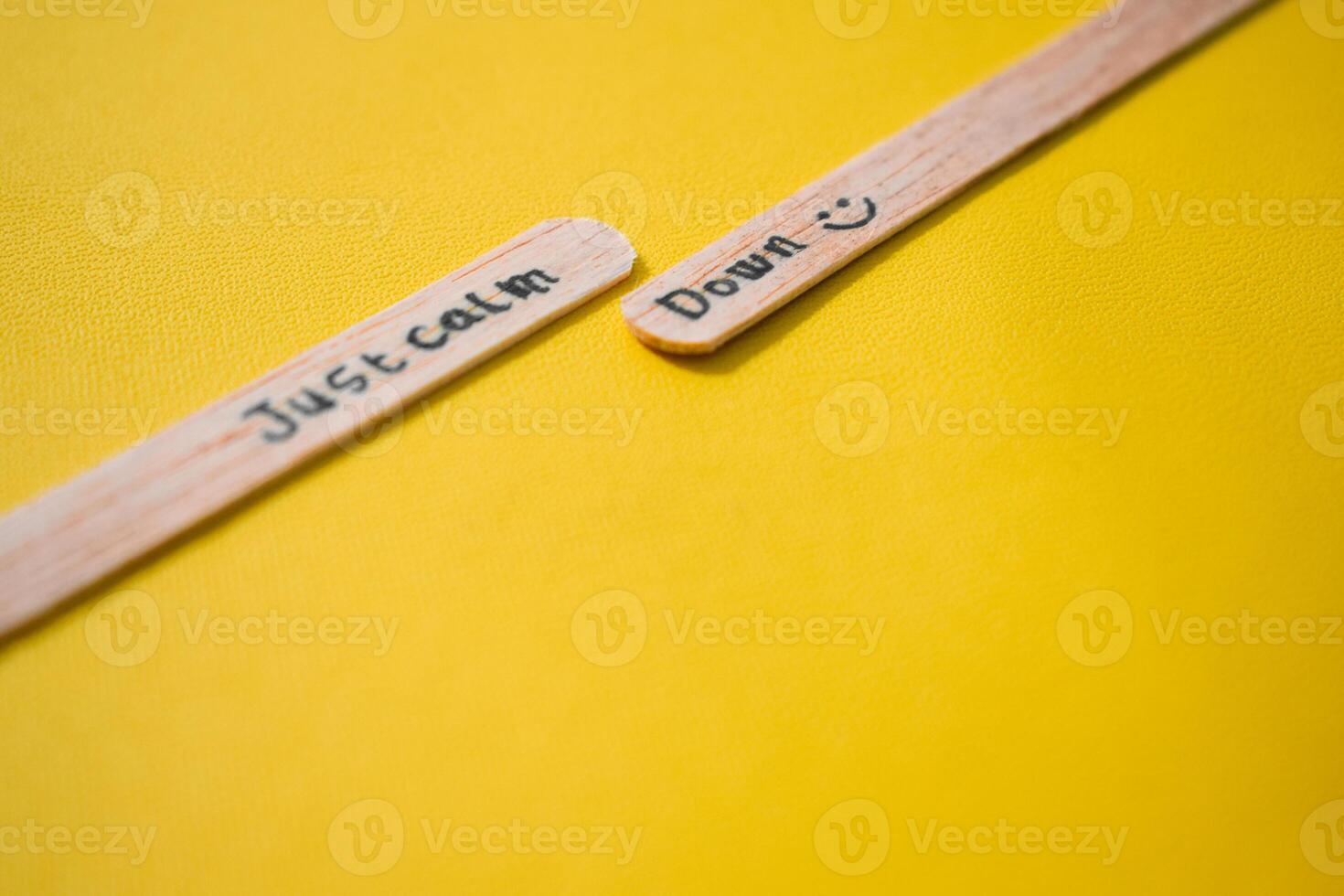 stick of ice cream with the words Just calm down. Motivational quotes, optimism, positive words. Isolated on background photo