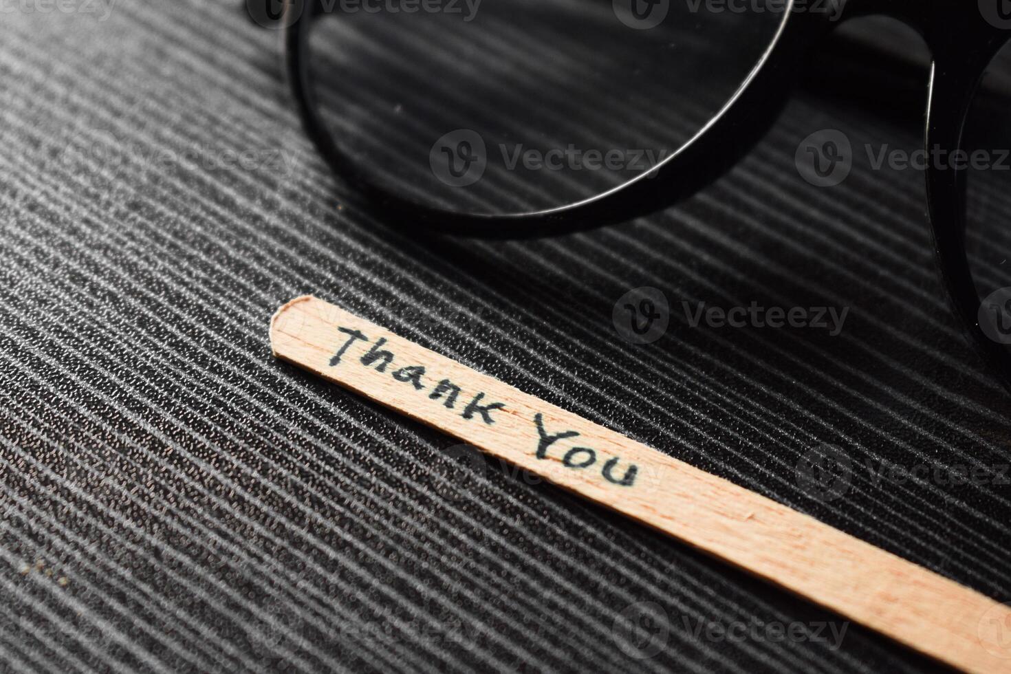 stick of ice cream with the words thank you and the eyeglasses. Motivational quotes, optimism, positive words on the table photo