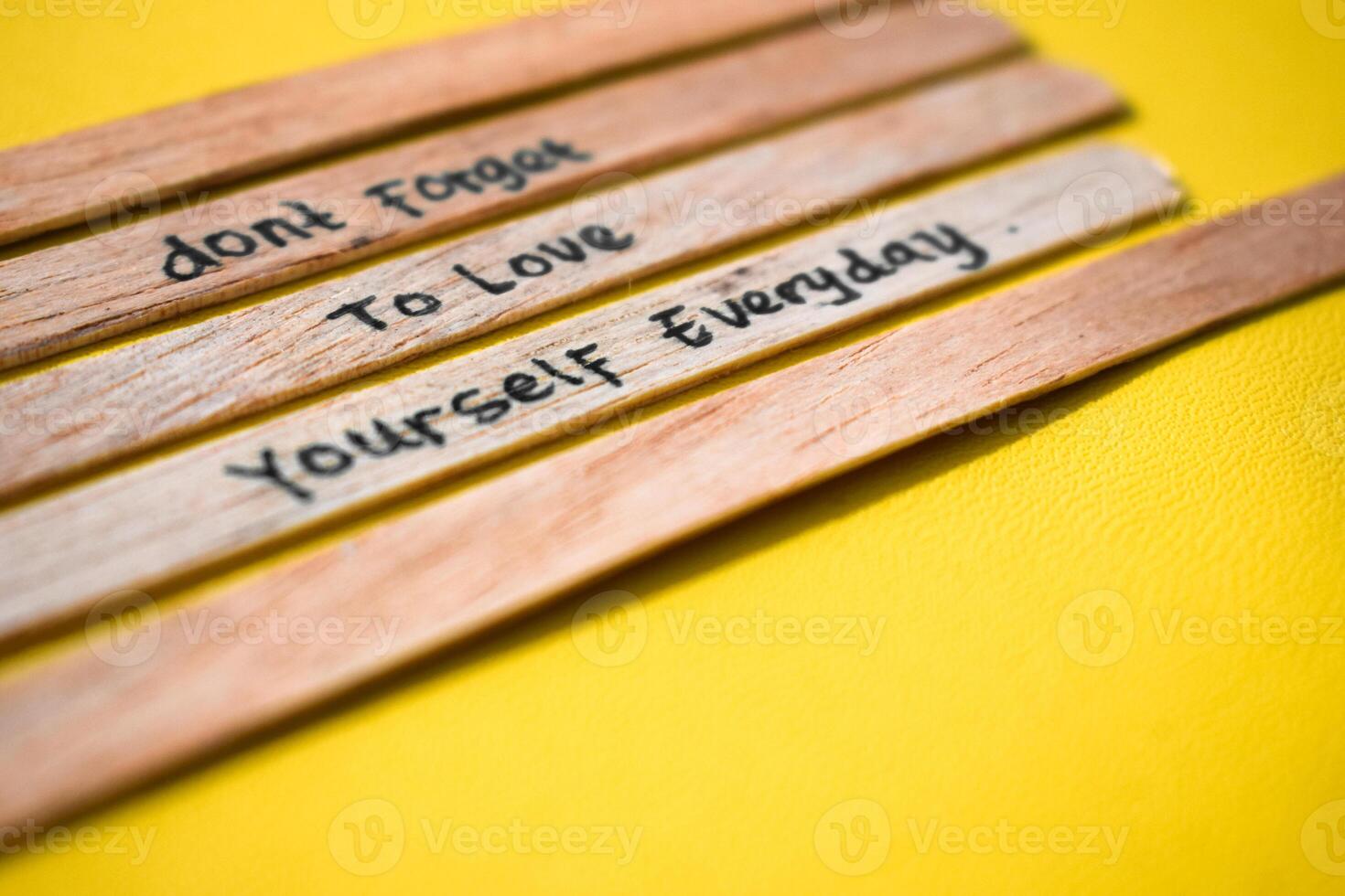 stick of ice cream with the words don't forget to love yourself everyday. Motivational quotes, optimism, positive words. Isolated on background photo