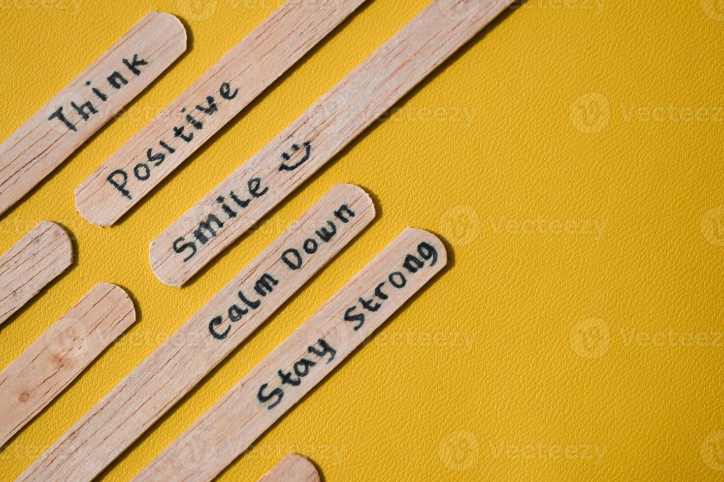 stick of ice cream with the words Think Positive, Smile, calm dowm, Stay strong. Motivational quotes, optimism, positive words. Isolated on background photo