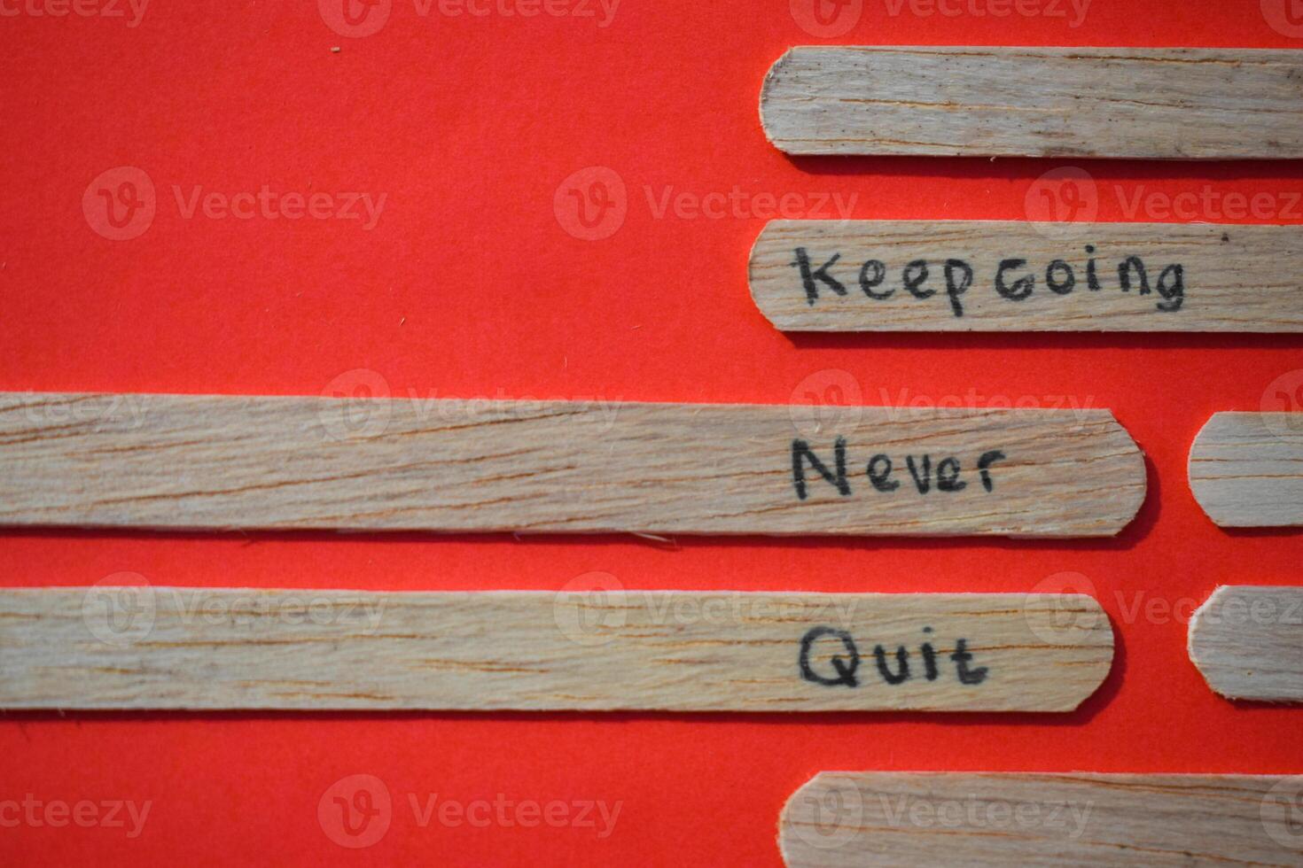 stick of ice cream with the words Keep going, Never quit. Motivational quotes, optimism, positive words. Isolated on background photo