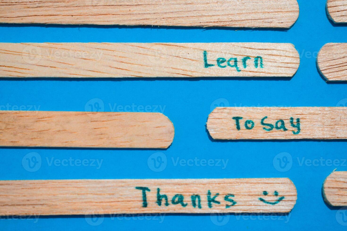 stick of ice cream with the words Learn to say Thanks. Motivational quotes, optimism, positive words. Isolated on background photo