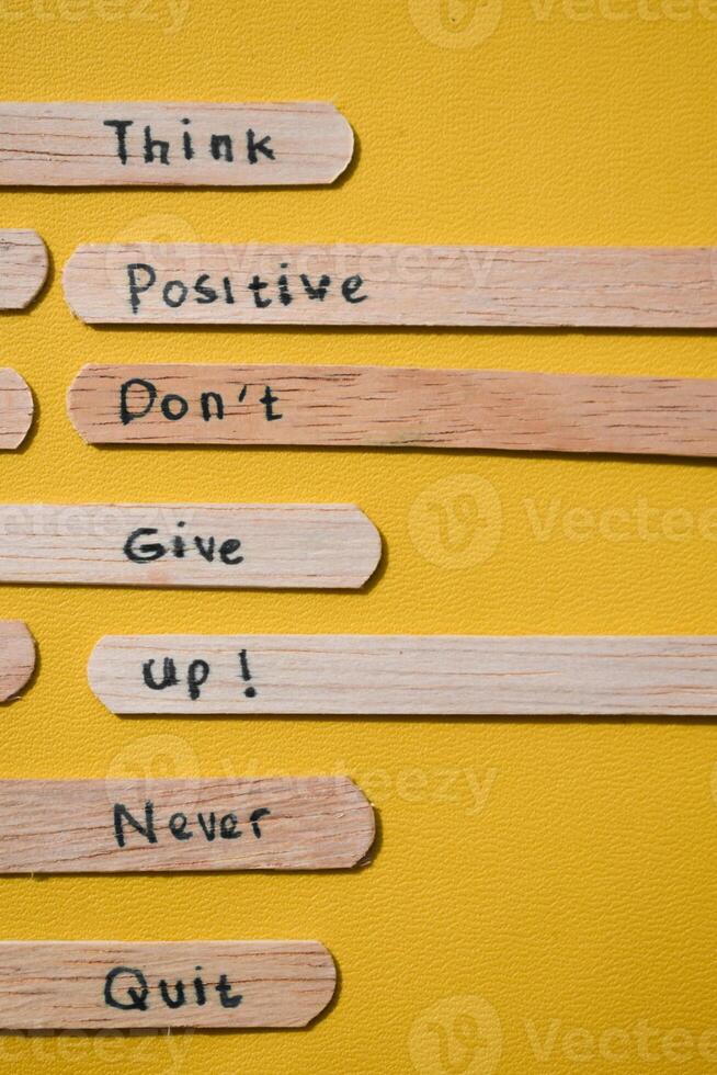 stick of ice cream with the words Think Positive, Dont give up, Never quit. Motivational quotes, optimism, positive words photo