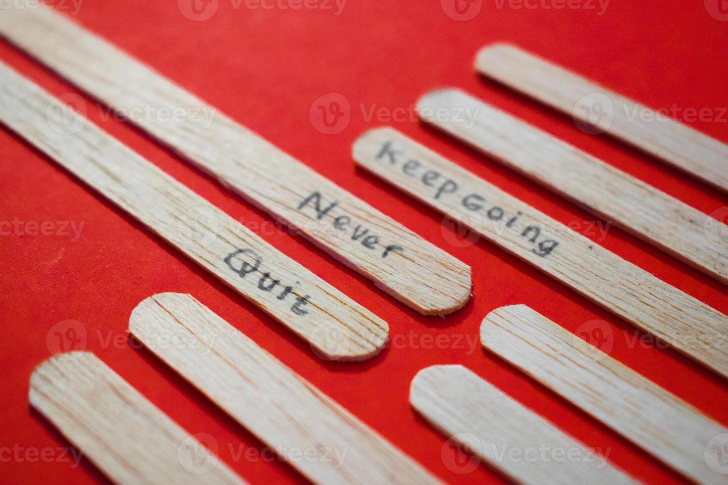 stick of ice cream with the words Keep going, Never quit. Motivational quotes, optimism, positive words. Isolated on background photo
