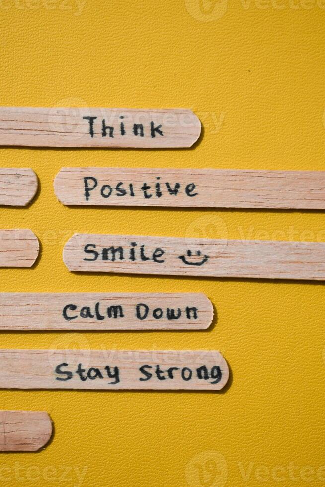 stick of ice cream with the words Think Positive, Smile, calm dowm, Stay strong. Motivational quotes, optimism, positive words. Isolated on background photo