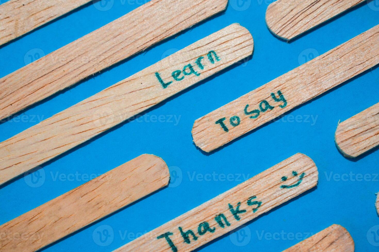 stick of ice cream with the words Learn to say Thanks. Motivational quotes, optimism, positive words. Isolated on background photo