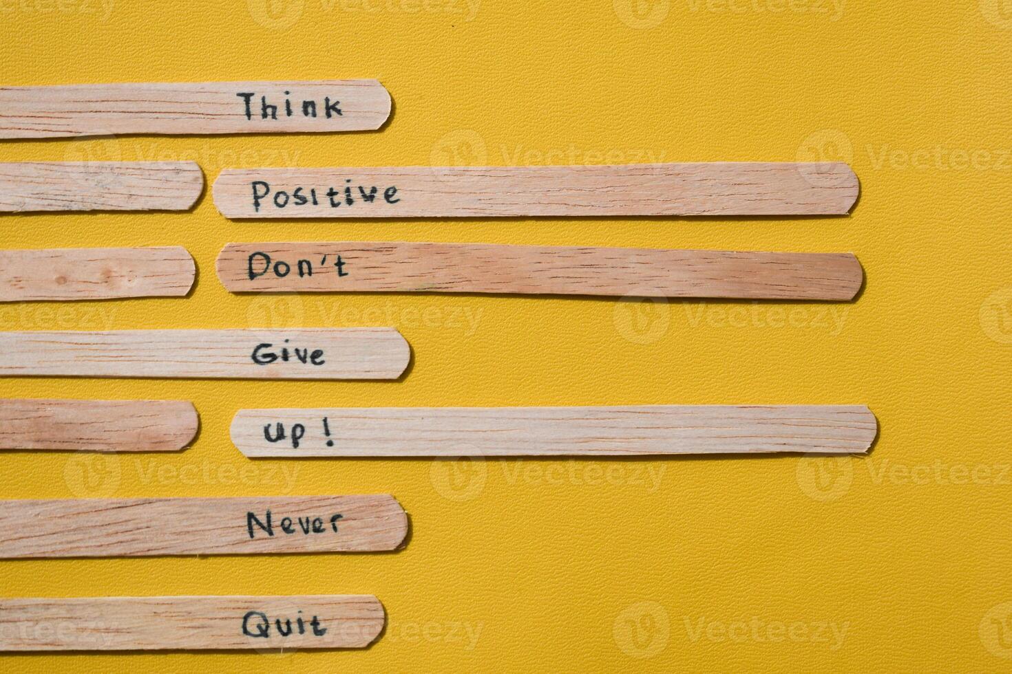 stick of ice cream with the words Think Positive, Dont give up, Never quit. Motivational quotes, optimism, positive words. Isolated on background photo