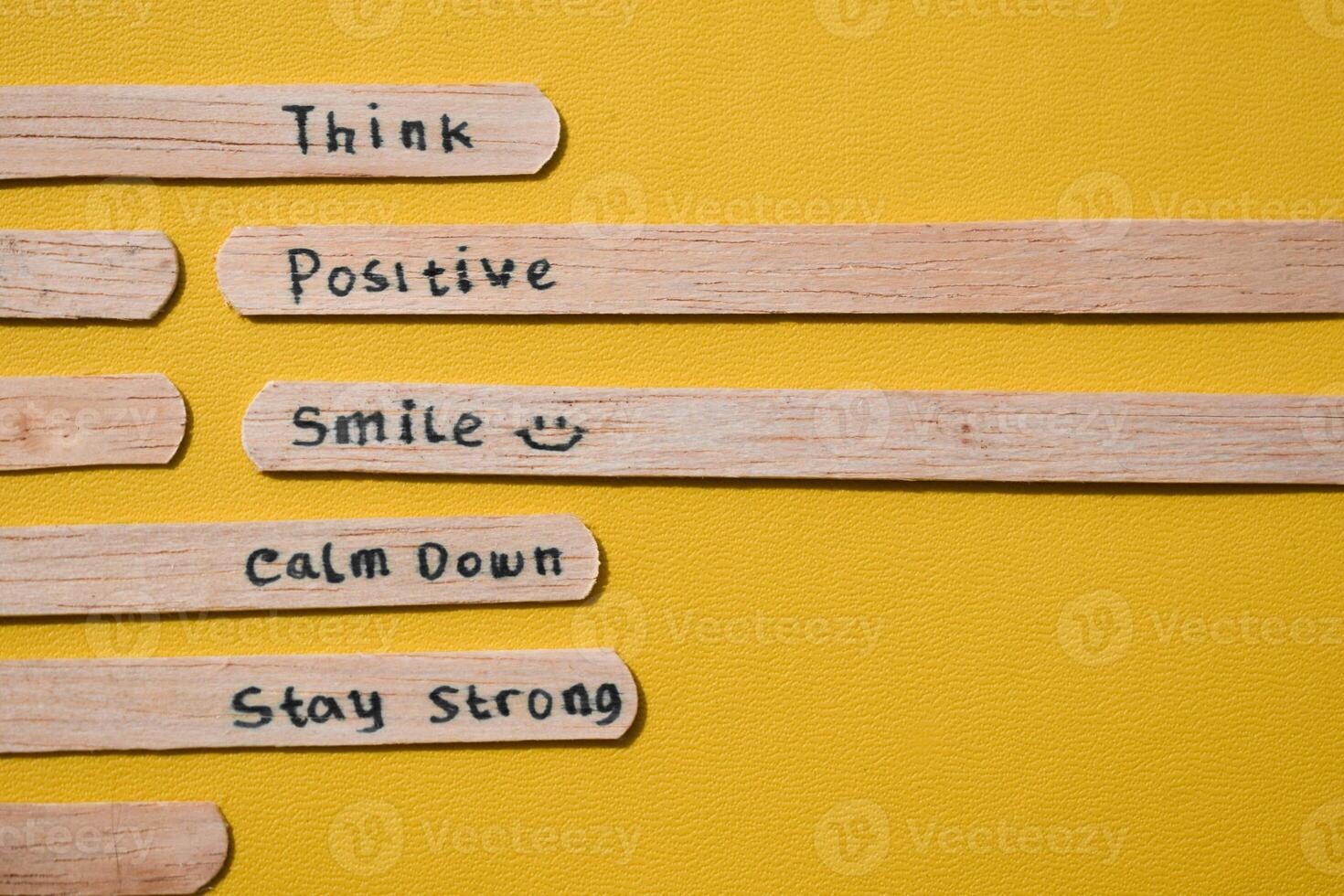 stick of ice cream with the words Think Positive, Smile, calm dowm, Stay strong. Motivational quotes, optimism, positive words. Isolated on background photo