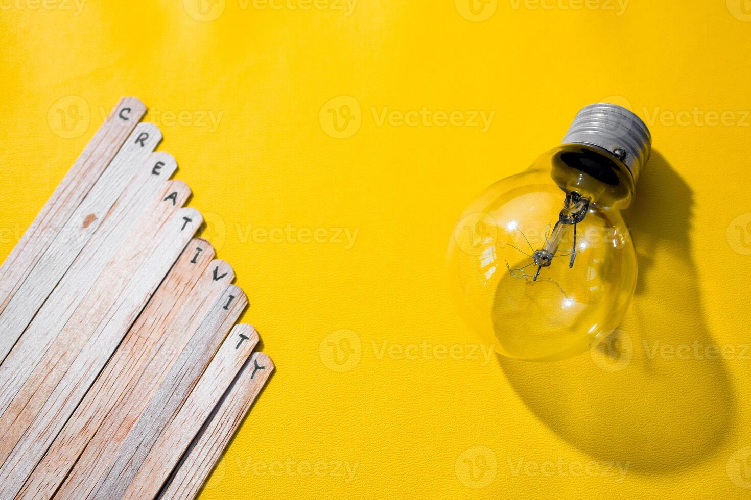 stick of ice cream with the words Creativity and lightbulb. Motivational quotes, optimism, positive words. Isolated on background photo