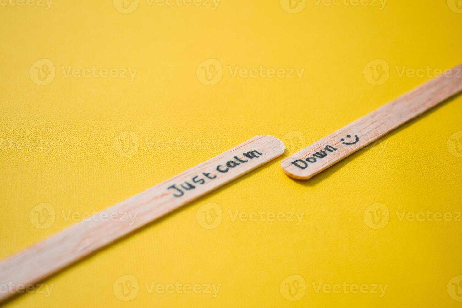 stick of ice cream with the words Just calm down. Motivational quotes, optimism, positive words. Isolated on background photo