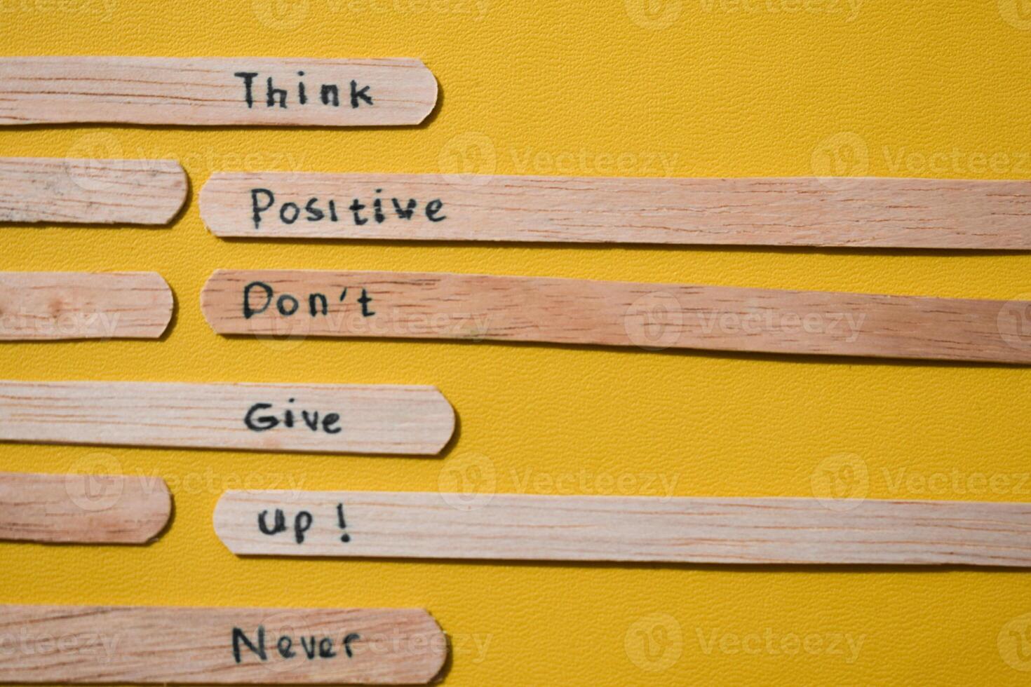 stick of ice cream with the words Think Positive, Dont give up, Never quit. Motivational quotes, optimism, positive words. photo