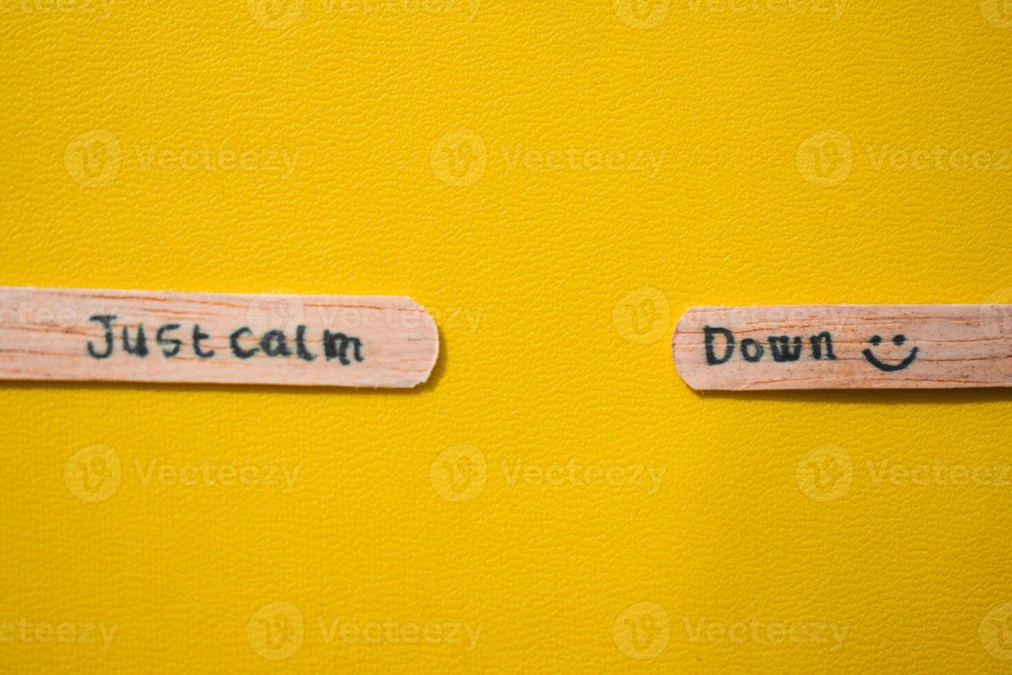 stick of ice cream with the words Just calm down. Motivational quotes, optimism, positive words. Isolated on background photo