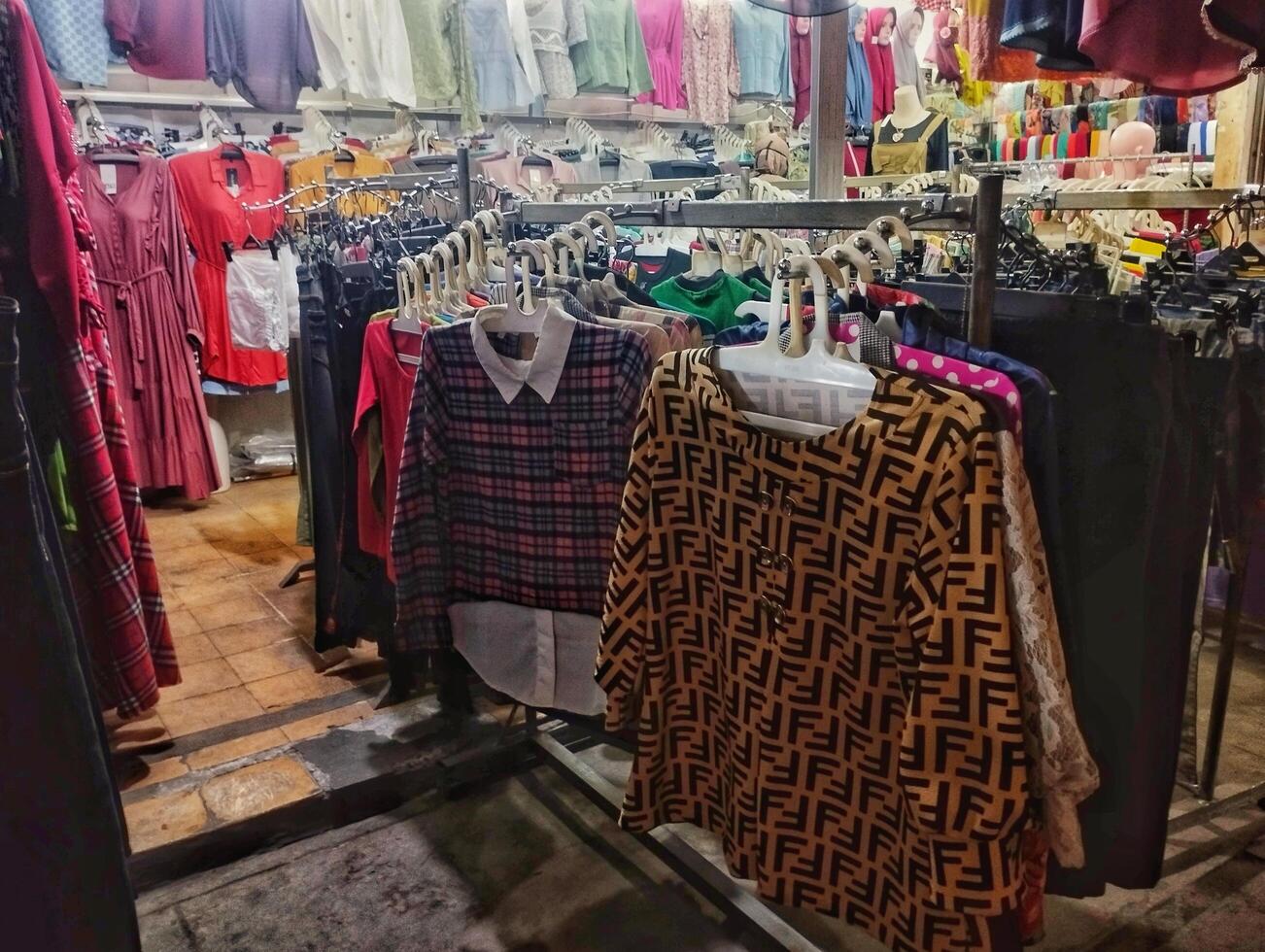 Pandaan, September 26, 2024 clothes sold in a traditional market photographed close up from a side angle photo