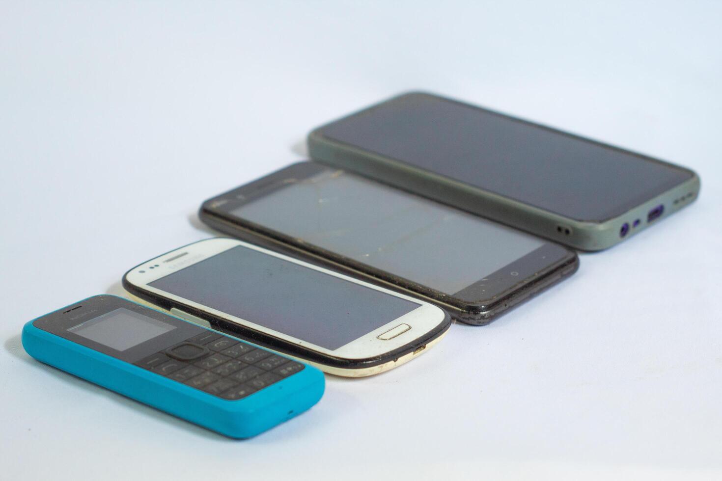 Mobile phones neatly arranged in a row and photographed from a side angle photo