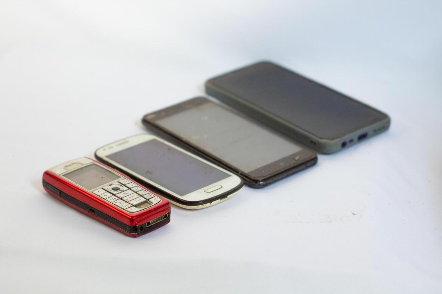 Mobile phones neatly arranged in a row and photographed from a side angle photo