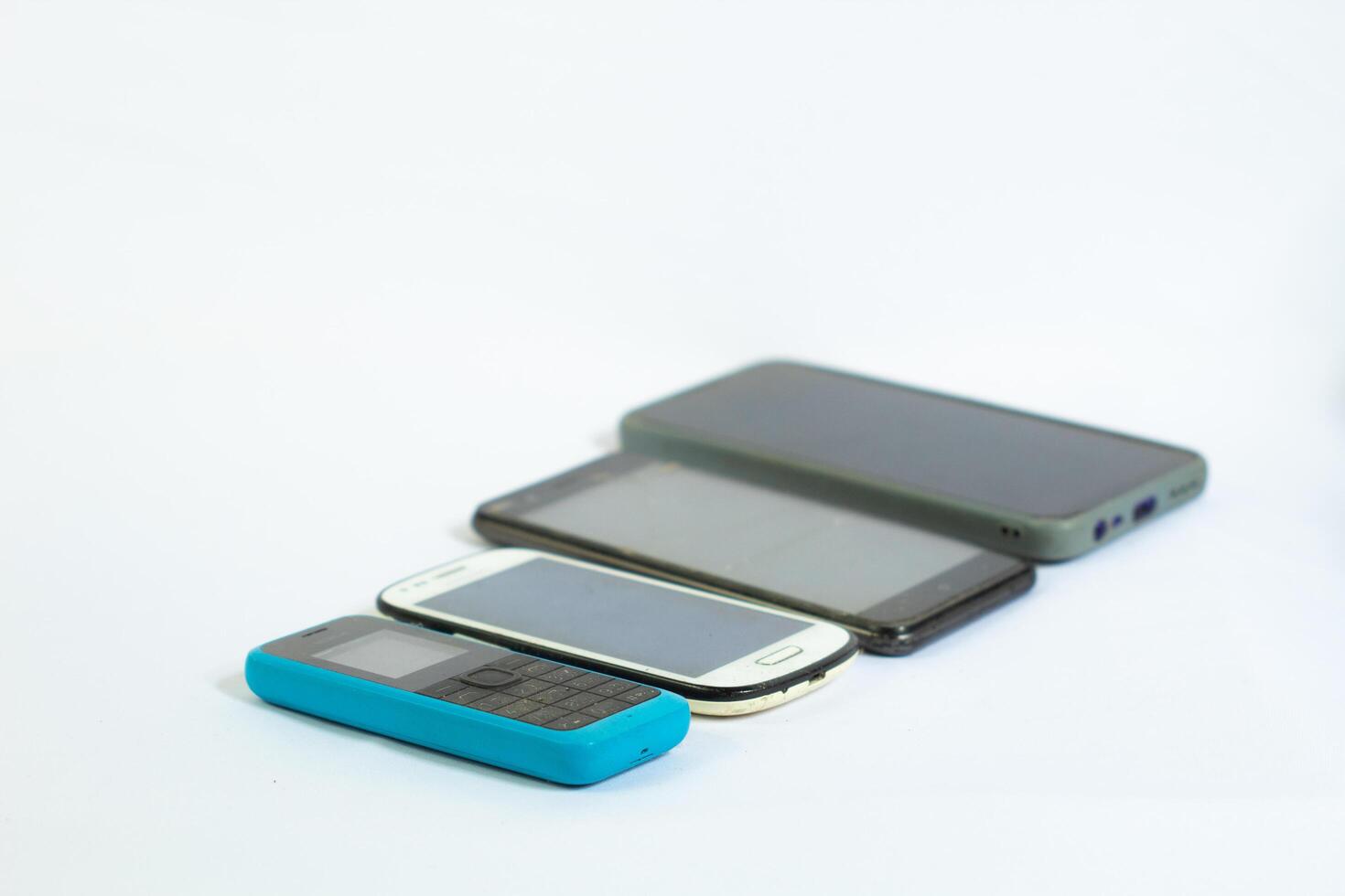 Mobile phones neatly arranged in a row and photographed from a side angle photo