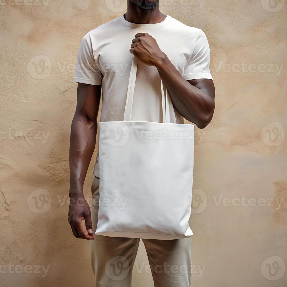 Tote bag mockup. Young African American man carrying white reusable cotton linen eco organic fabric canvas blank totebag on yellow background. photo