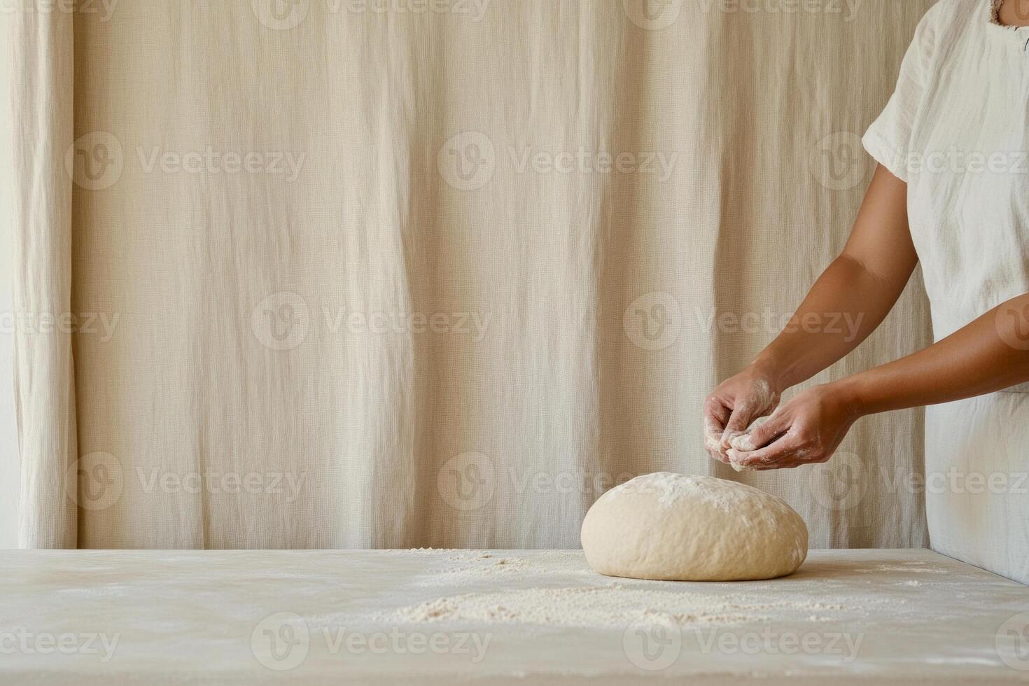 A woman skillfully preparing bread dough in a rustic kitchen with warm beige tones and sandstone countertops photo