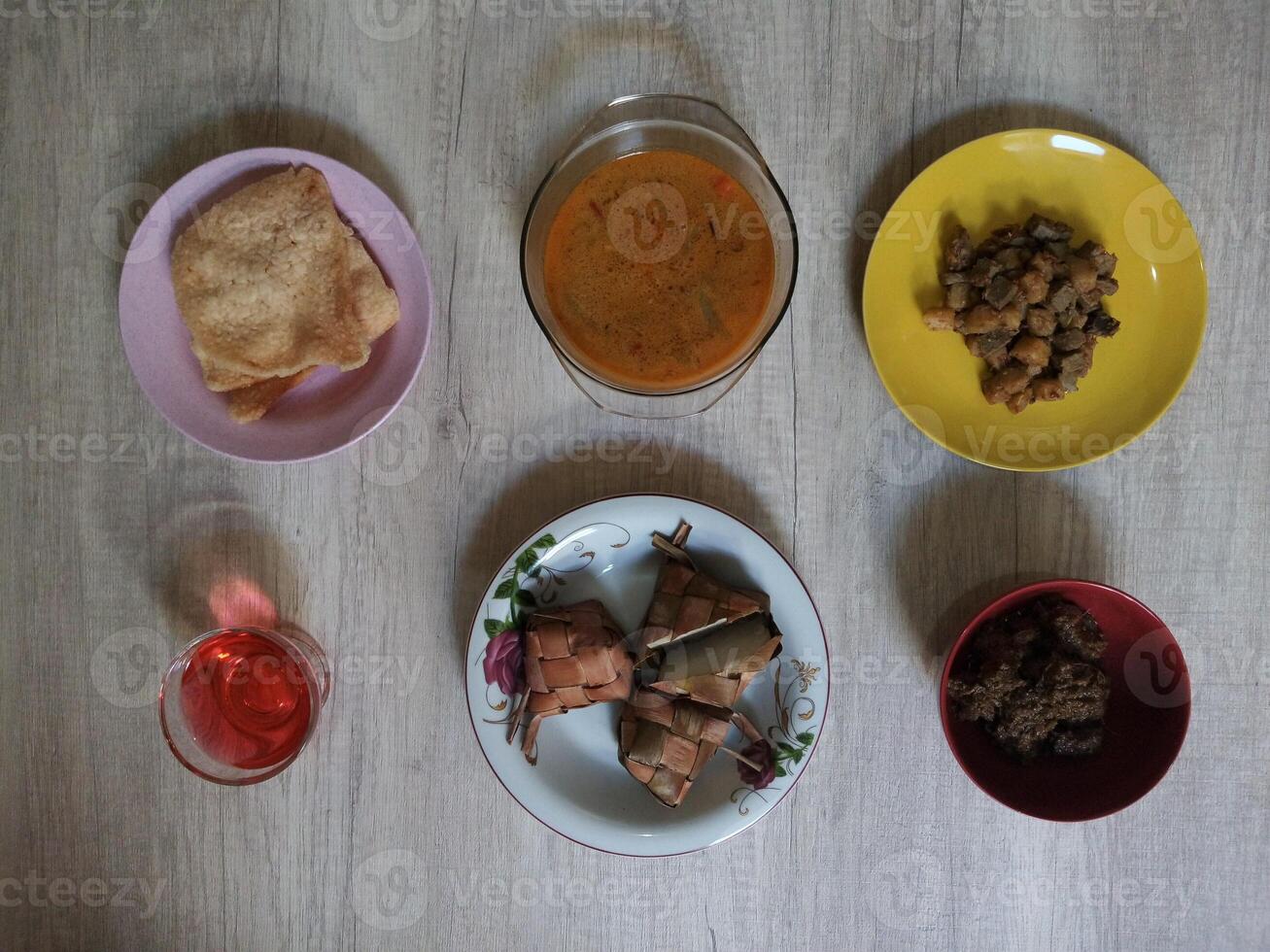 Variety of delicious Indonesian typical home cooked dishes served on the table on Eid al-Fitr from high angle view photo