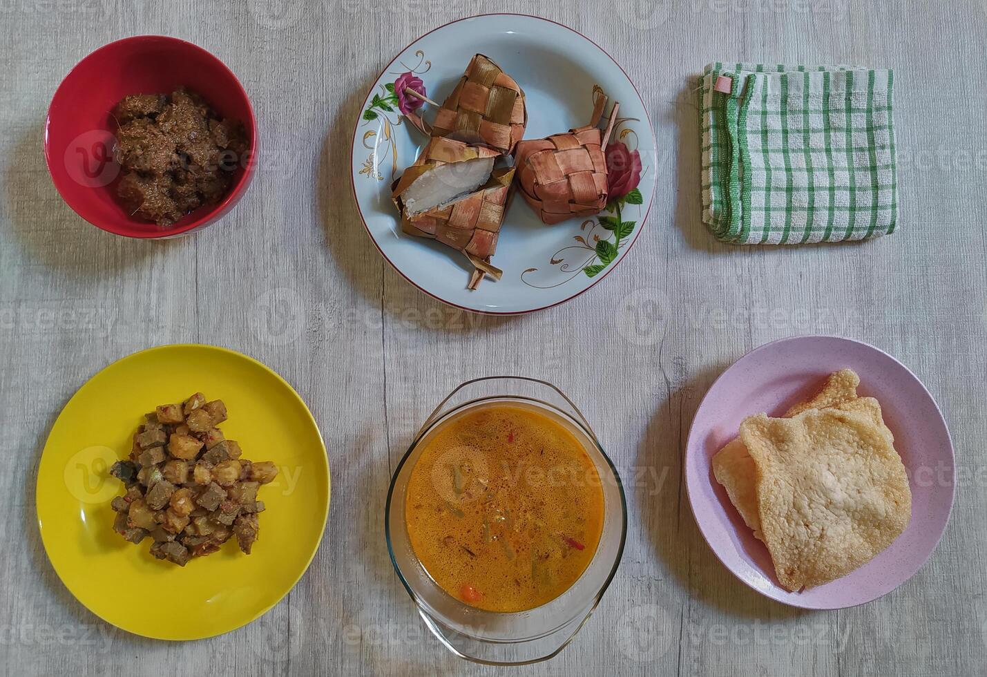 Variety of delicious Indonesian typical home cooked dishes served on the table on Eid al-Fitr from high angle view photo