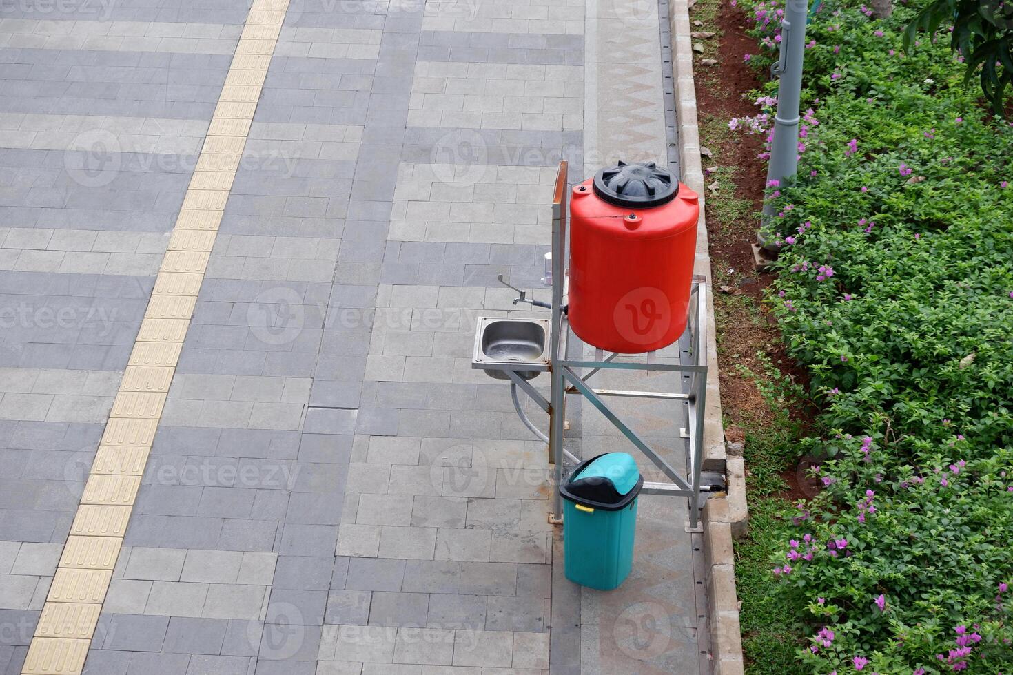 Public hand washing facilities on the sidewalk of Sudirman Street, Jakarta. The handwashing facilities installed widely in the public area to prevent spread of Covid-19 viruses photo