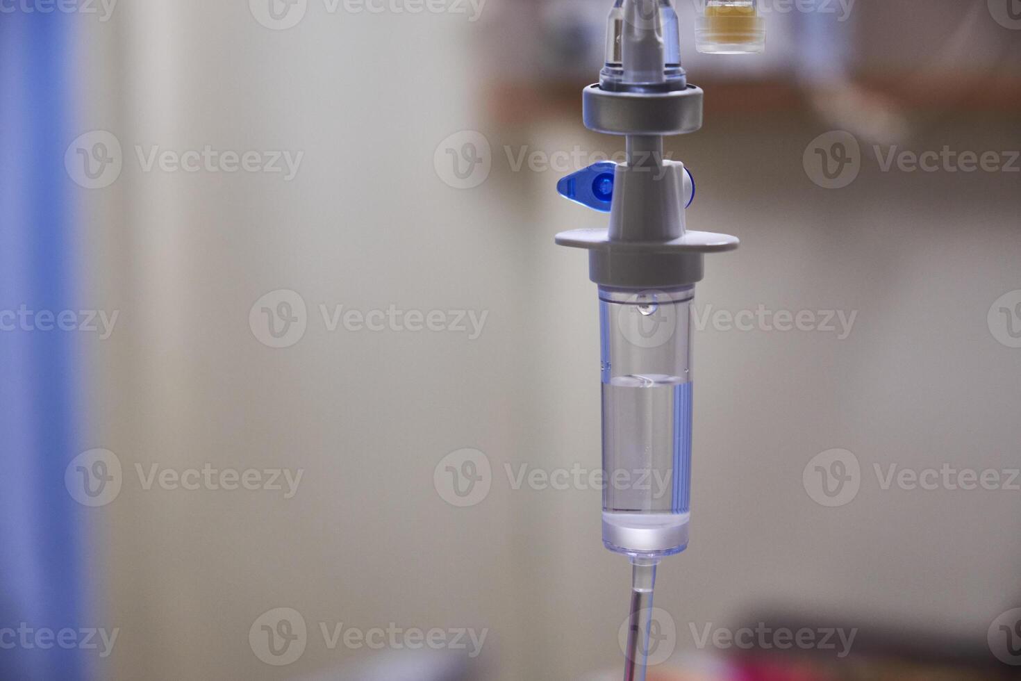 Close-up of slow iv fluid intravenous drip saline with blurred background in a hospital room, medical concept with copy space photo