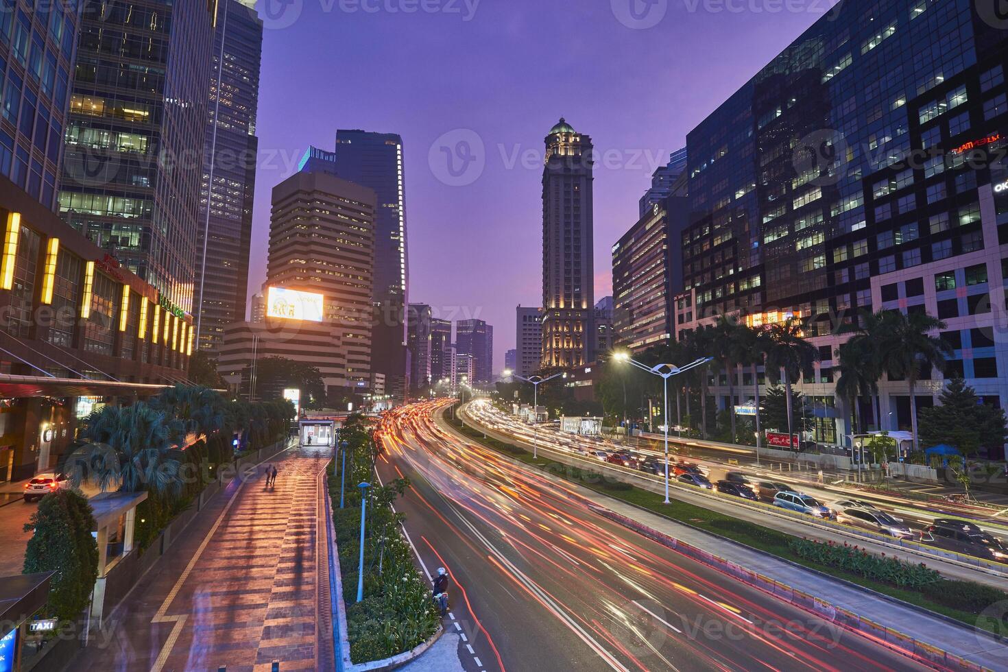 Traffic conditions in main road of Jakarta business center with office buildings photo