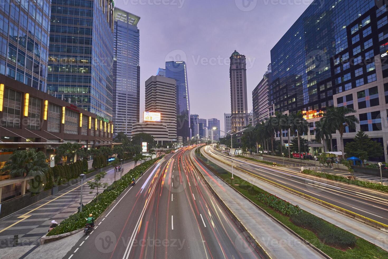 Traffic conditions in main road of Jakarta business center with office buildings photo