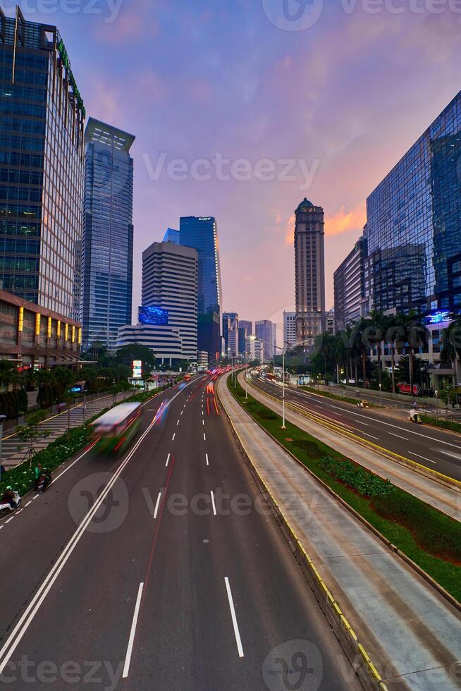 Traffic conditions in main road of Jakarta business center with office buildings photo