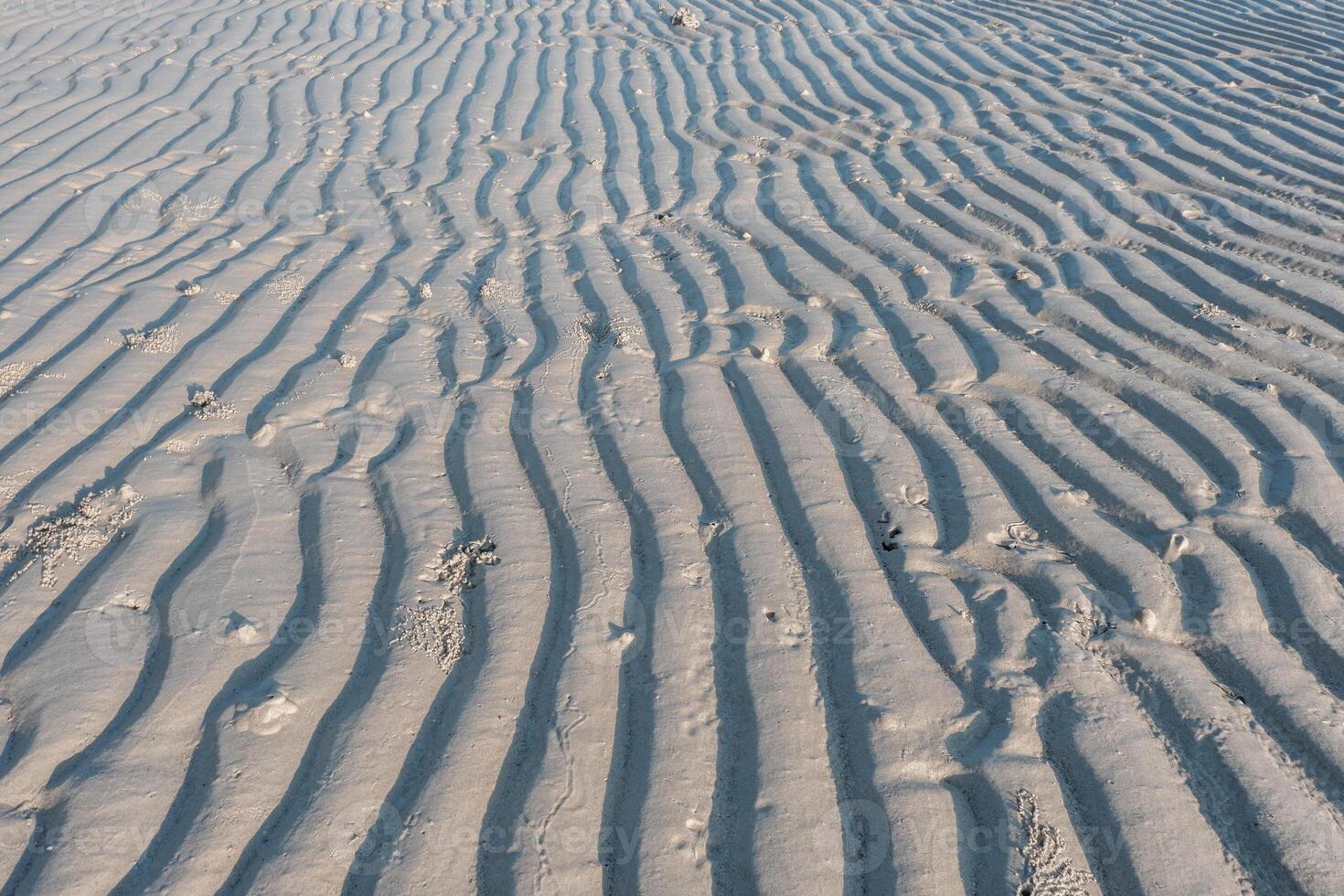 Line pattern on sand created by waves in Belitung Island beach, Indonesia. Belitung is one of the most popular tourist destinations in Indonesia. photo