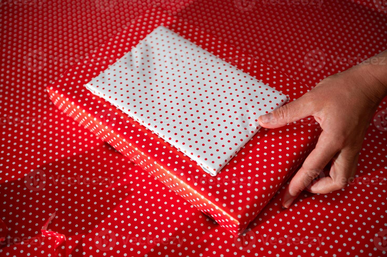 Gift wrapping in festive red and white polka dot paper creating a joyful and celebratory mood photo